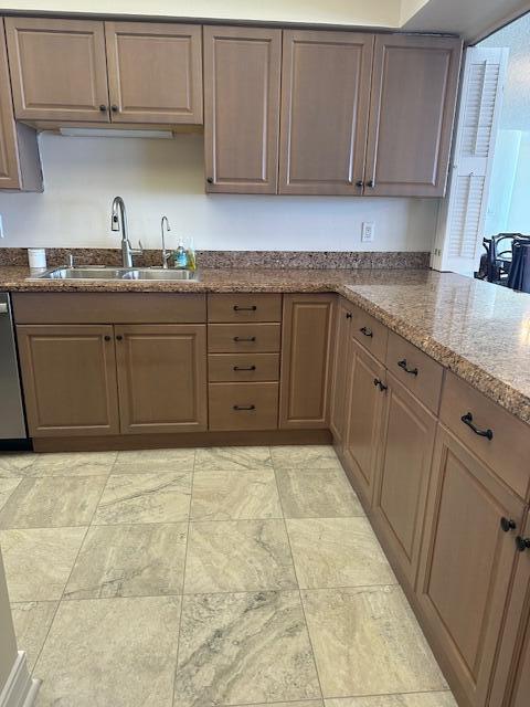 2001 Southeast Sailfish Point Boulevard, Unit 316 Stuart, FL 34996 - Photo 7 of 39 a kitchen with a sink and cabinets