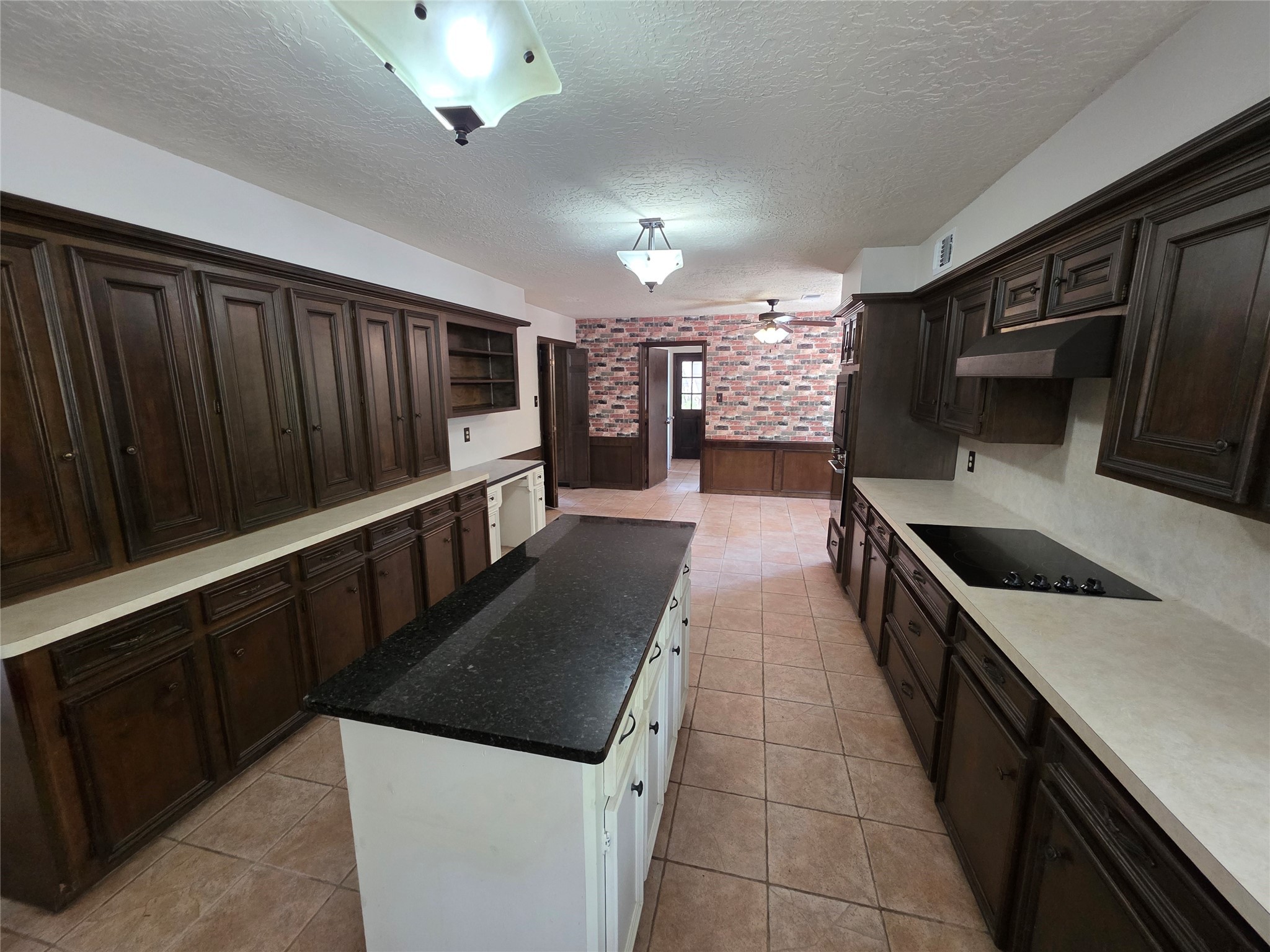 18 Mayfair Grove Court The Woodlands, TX 77381 - Photo 11 of 28 a kitchen with stainless steel appliances a stove a sink and a refrigerator