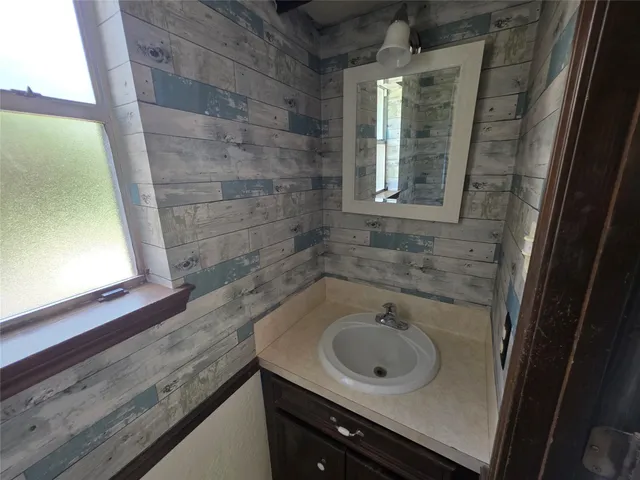 a bathroom with a sink and a window