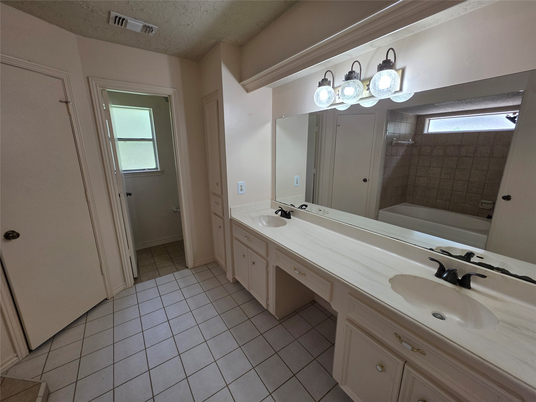 18 Mayfair Grove Court The Woodlands, TX 77381 - Photo 15 of 28 a bathroom with a double vanity sink mirror and shower