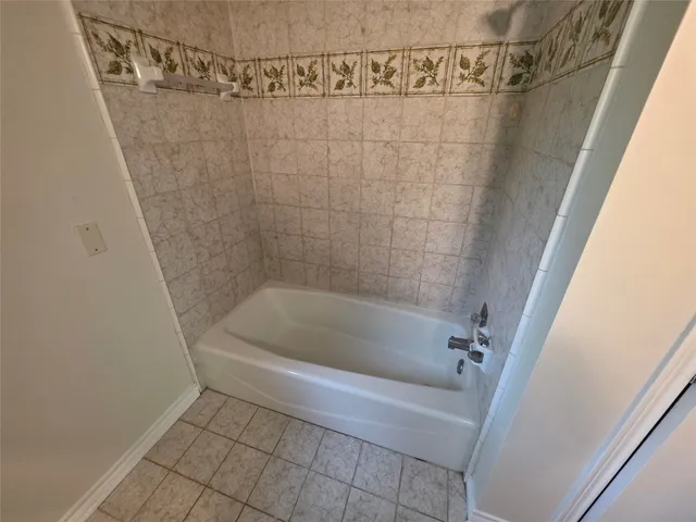 a bath tub sitting next to a shower