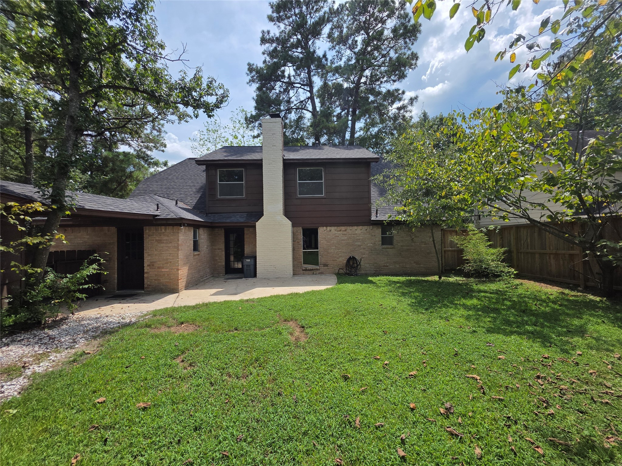 18 Mayfair Grove Court The Woodlands, TX 77381 - Photo 27 of 28 a view of a house with a yard and a large tree