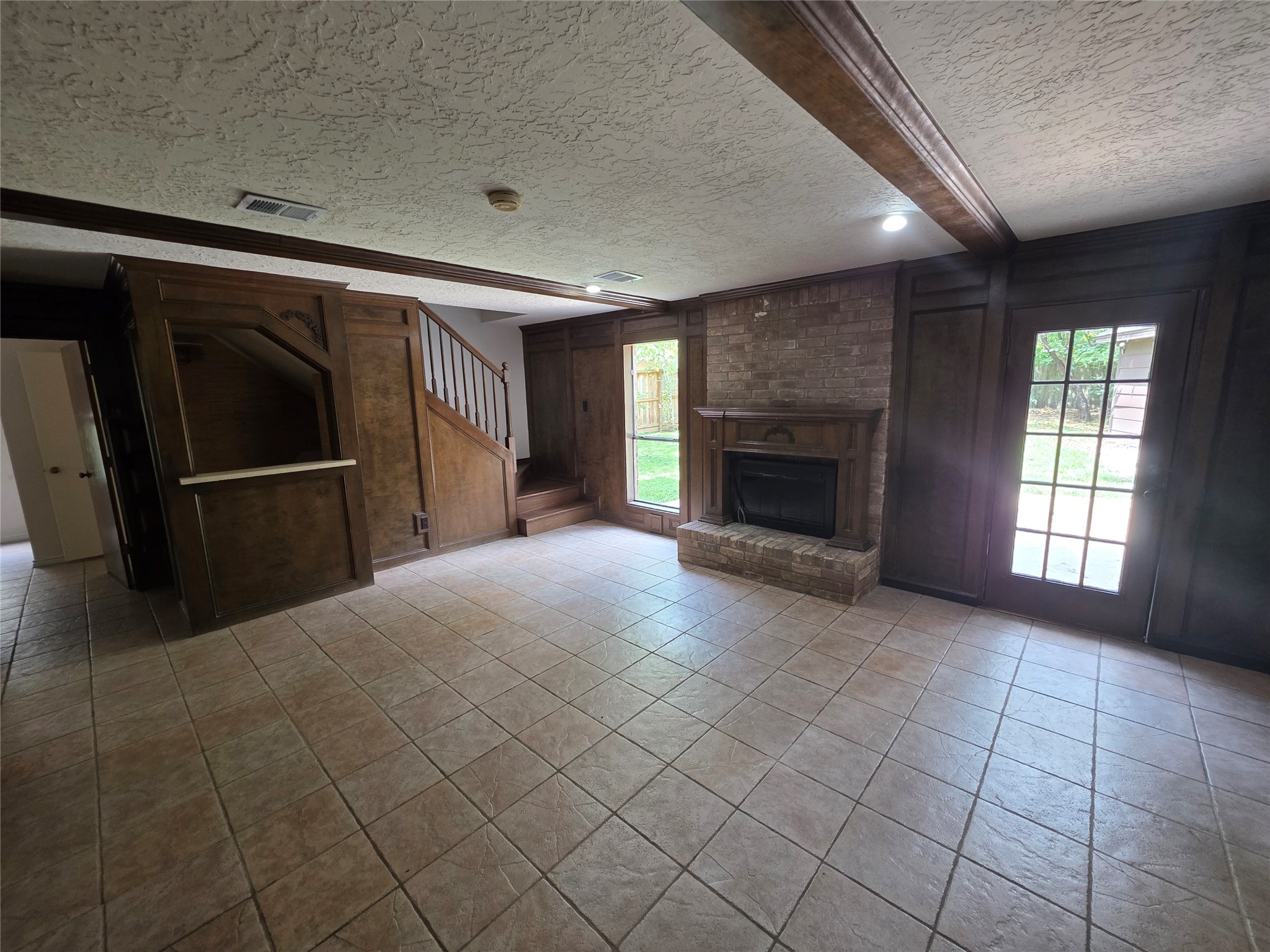 18 Mayfair Grove Court The Woodlands, TX 77381 - Photo 5 of 28 an empty room with windows and fireplace