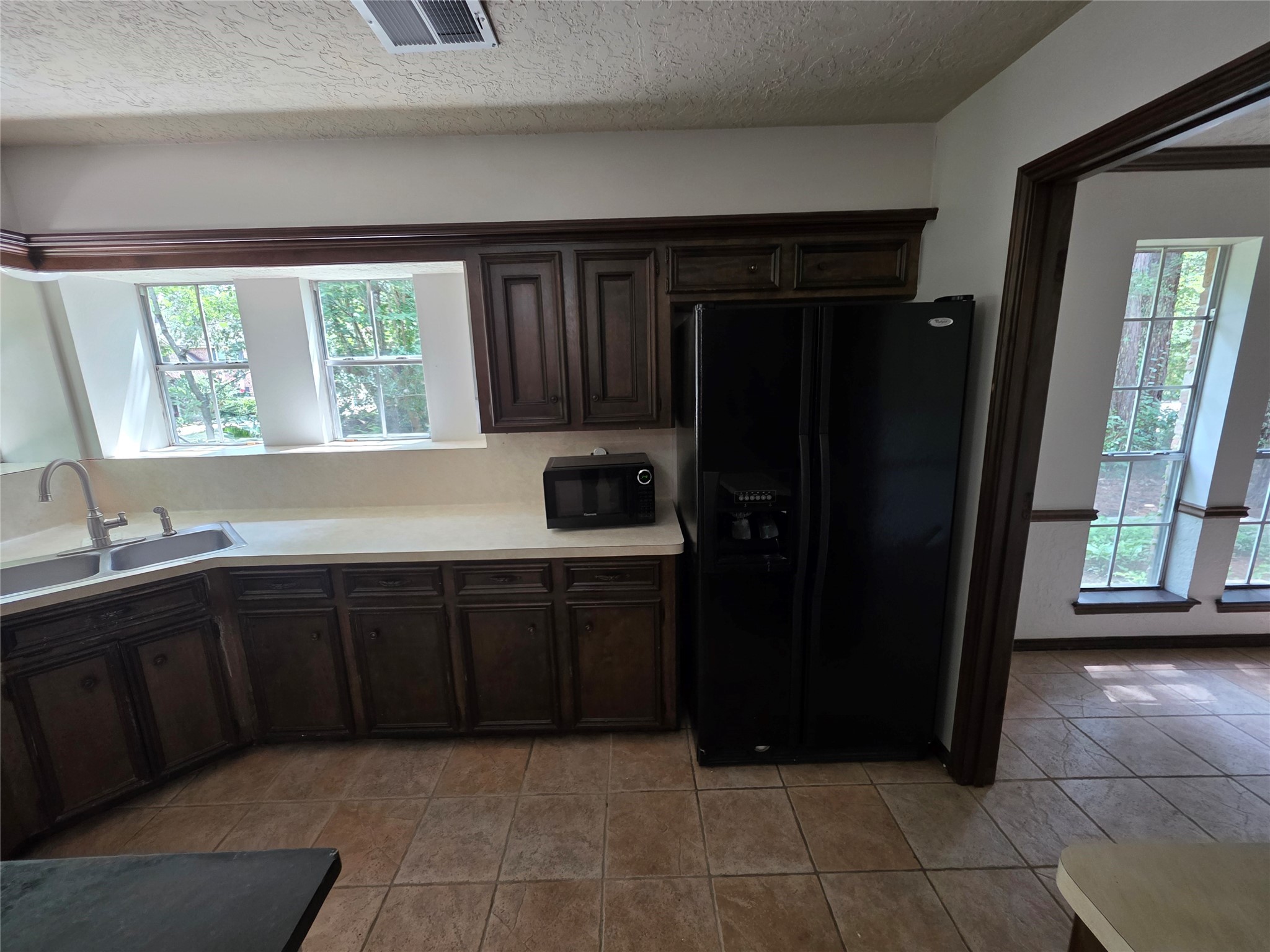 18 Mayfair Grove Court The Woodlands, TX 77381 - Photo 9 of 28 a kitchen with a refrigerator and window