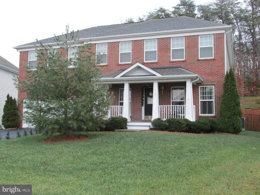 4145 Agency Loop Triangle, VA 22172 - Photo 1 of 24 a front view of a house with garden