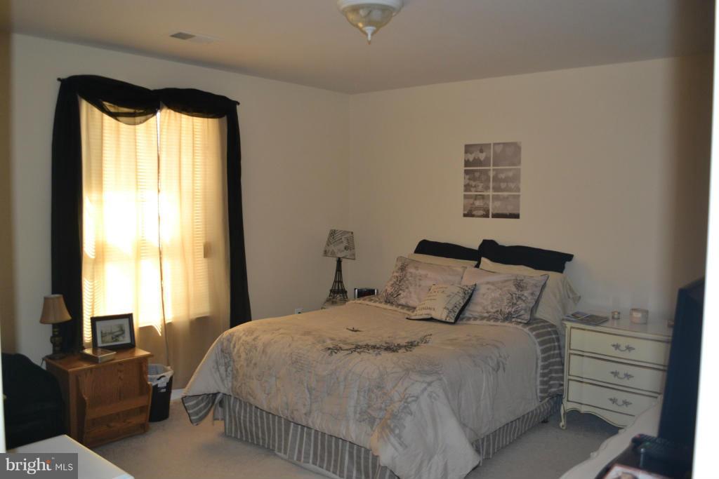 4145 Agency Loop Triangle, VA 22172 - Photo 13 of 24 a bedroom with a bed and a window