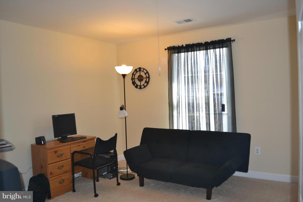 4145 Agency Loop Triangle, VA 22172 - Photo 14 of 24 a view of a workspace with furniture and a window