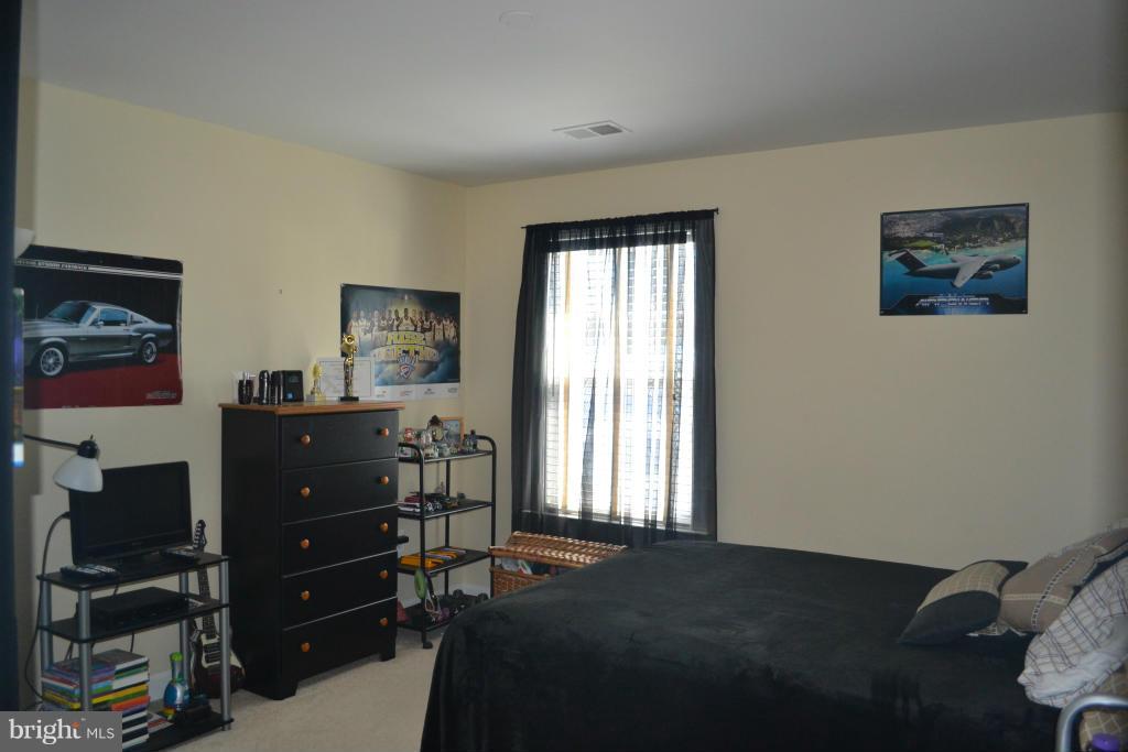 4145 Agency Loop Triangle, VA 22172 - Photo 15 of 24 a bed room with a bed and a window