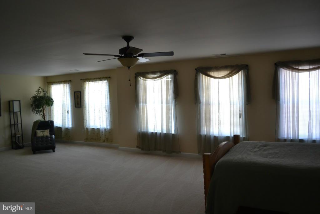 4145 Agency Loop Triangle, VA 22172 - Photo 17 of 24 a bed sitting in a bedroom next to a window