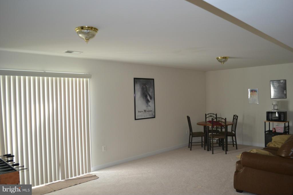 4145 Agency Loop Triangle, VA 22172 - Photo 20 of 24 a view of a livingroom with furniture and workspace