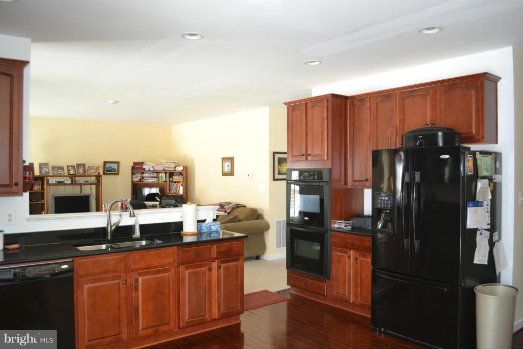 4145 Agency Loop Triangle, VA 22172 - Photo 6 of 24 a kitchen with stainless steel appliances granite countertop a refrigerator and a sink
