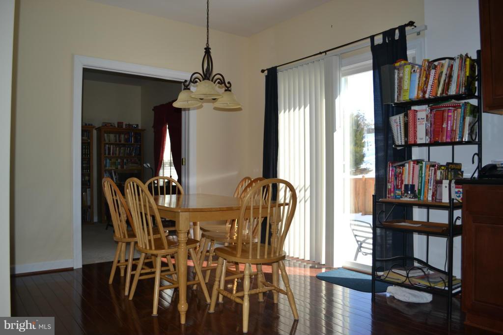 4145 Agency Loop Triangle, VA 22172 - Photo 8 of 24 a view of a dining room with furniture and a window