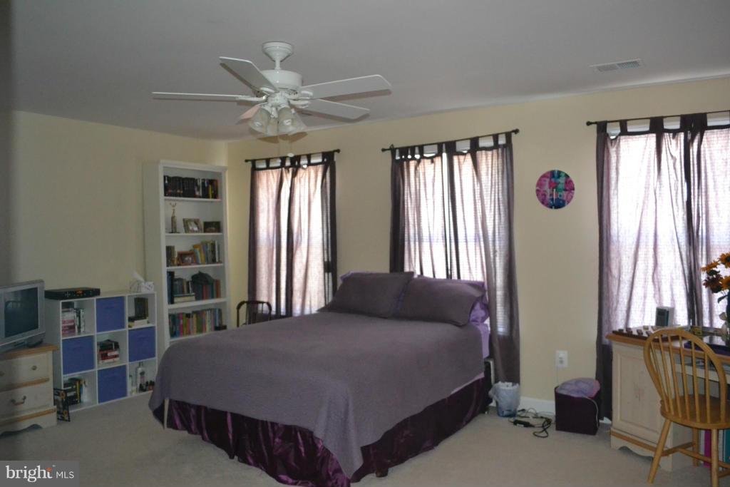 4145 Agency Loop Triangle, VA 22172 - Photo 10 of 24 a bedroom with a bed closet and window
