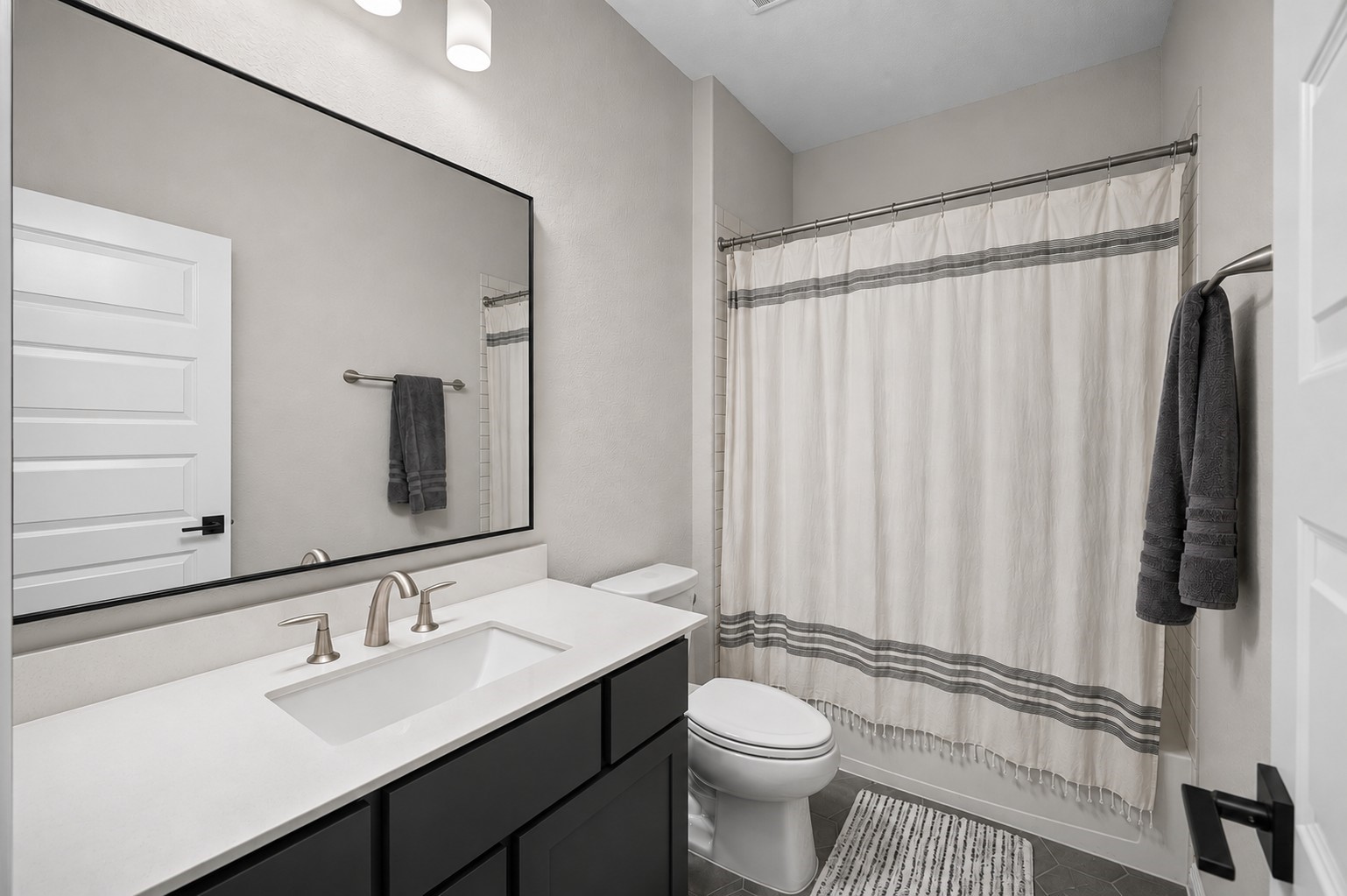4923 Grapevine Lane Manvel, TX 77578 - Photo 36 of 49 a bathroom with a sink a toilet a mirror and shower curtain