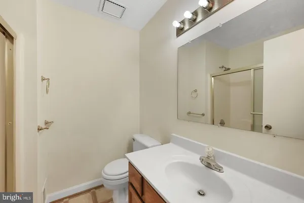 a bathroom with a sink toilet and a mirror