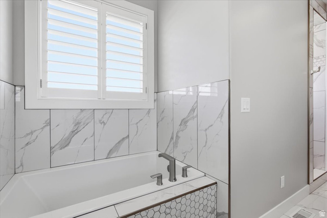 21 Pier Place Tooele, UT 84074 - Photo 36 of 112 Built-in soaking tub with a deck-mounted faucet and elegant tile surround