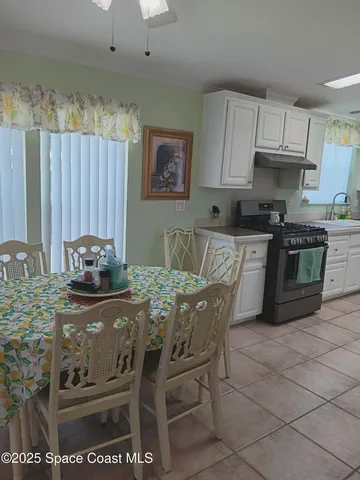 a kitchen with stainless steel appliances kitchen island granite countertop a sink and cabinets