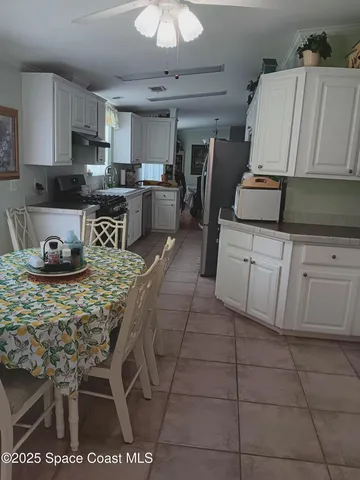 a view of a dining room with furniture and a chandelier