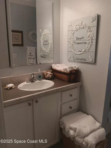 a large bed sitting in a bedroom next to a wooden cabinet