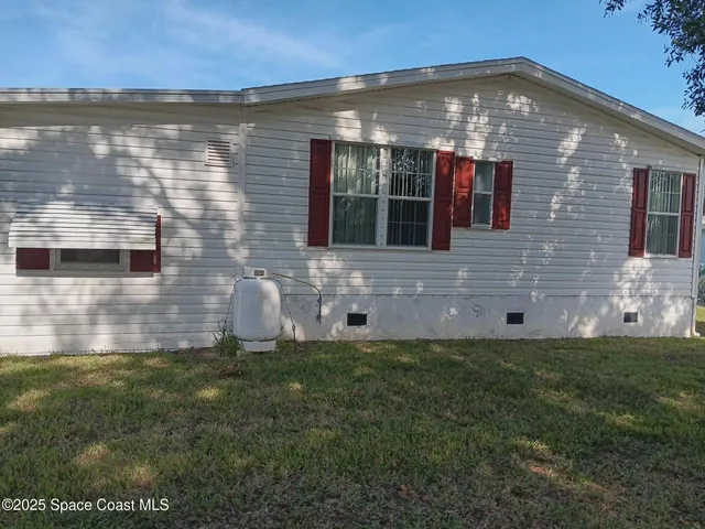 a view of a field with large trees