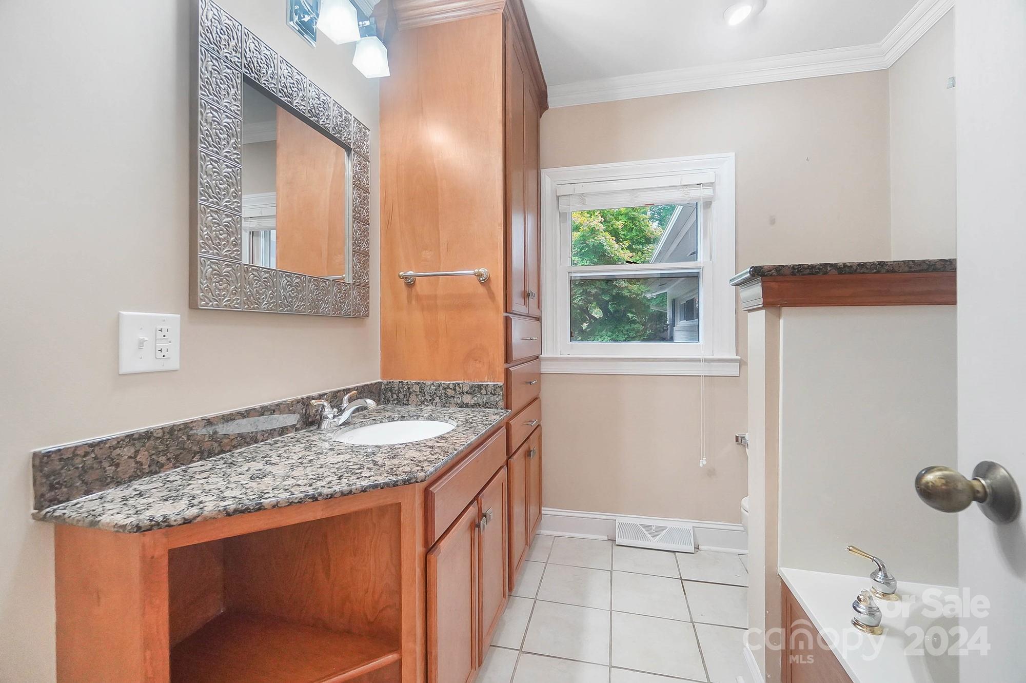 107 Ridge Avenue Clover, SC 29710 - Photo 20 of 48 a bathroom with a granite countertop sink and a mirror