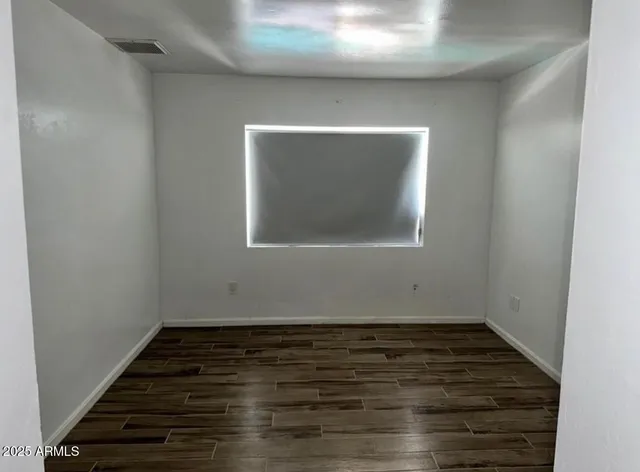 a view of room with wooden floor