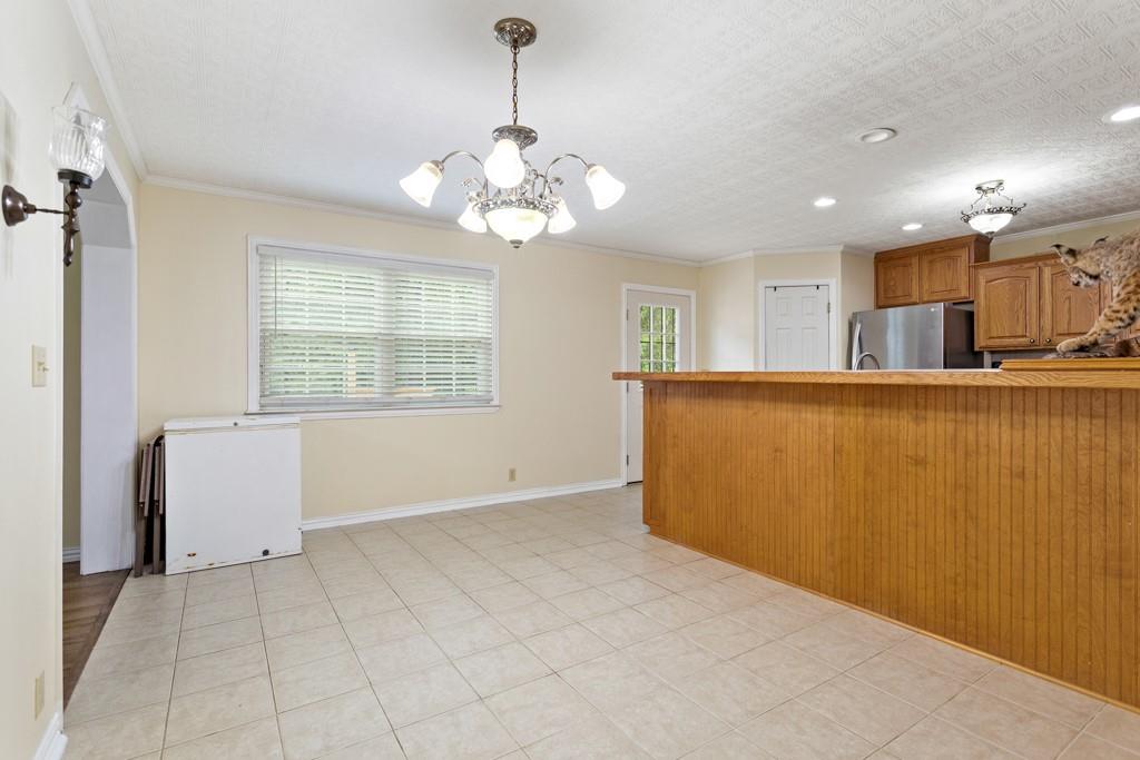 448 North Hill Road Tyler, TX 75706 - Photo 11 of 33 a view of a livingroom with a chandelier furniture and windows