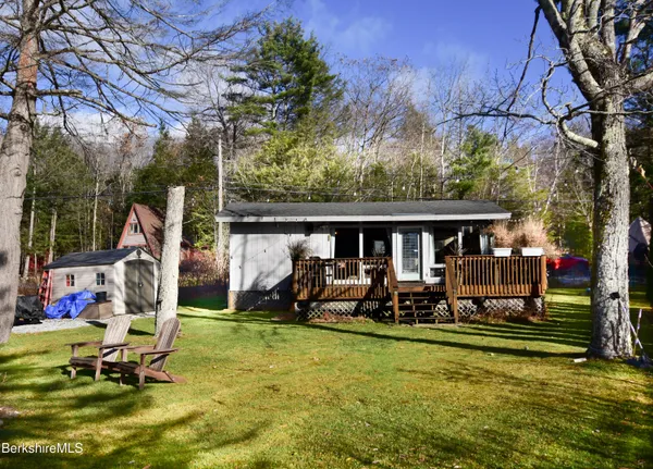 a view of a house with a backyard