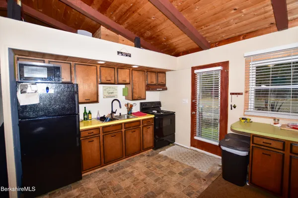 a kitchen with a table chairs and a refrigerator