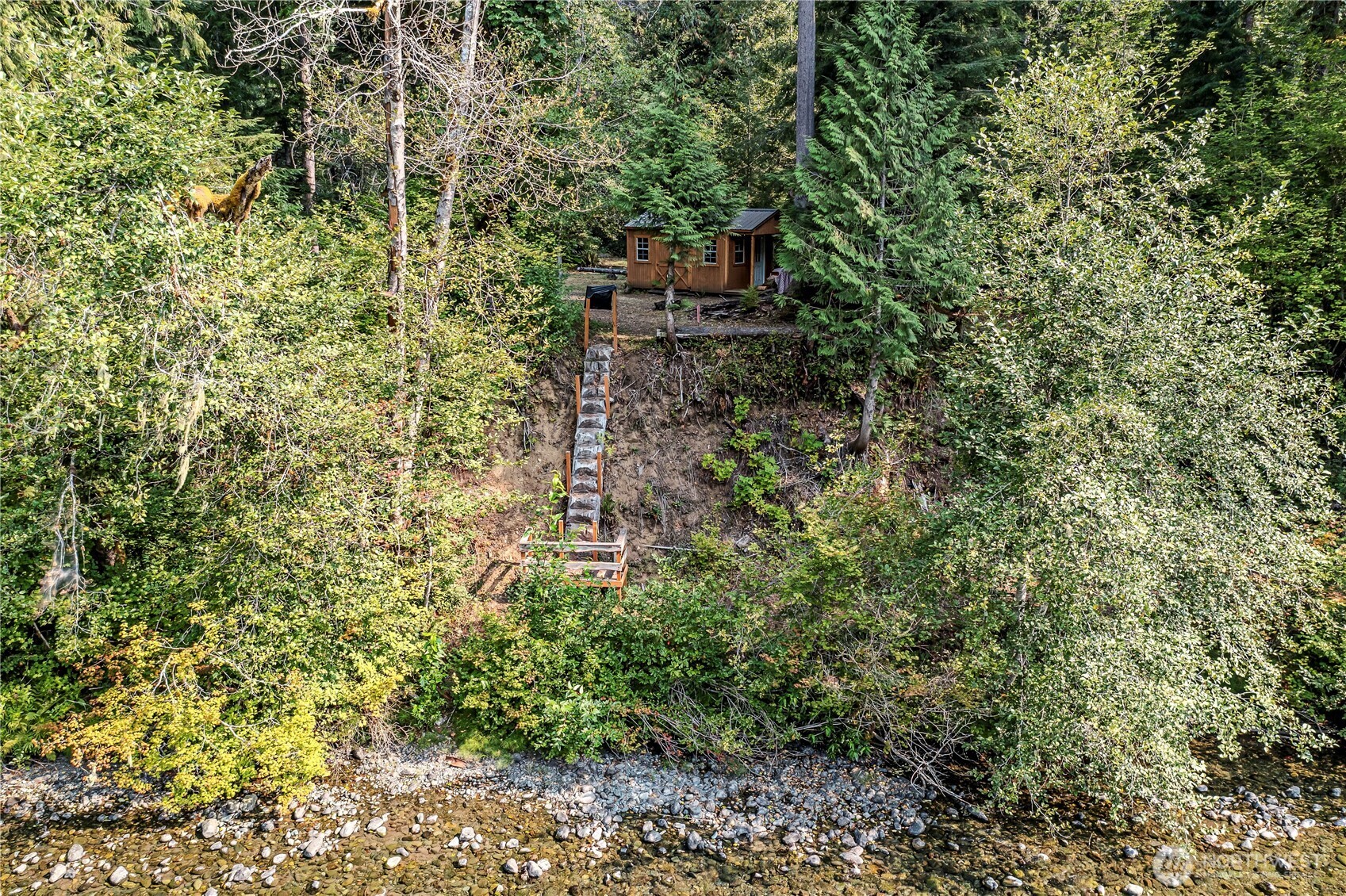 0 North Duckabush Road Brinnon, WA 98320 - Photo 21 of 29 a backyard of a house with lots of plants and trees
