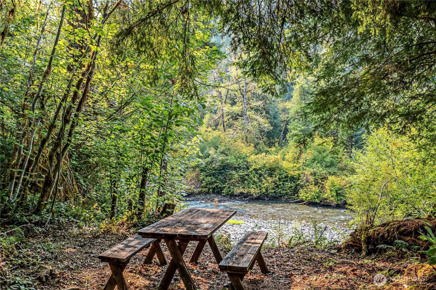 0 North Duckabush Road Brinnon, WA 98320 - Photo 24 of 29 a view of a patio with table and chairs and wooden floor