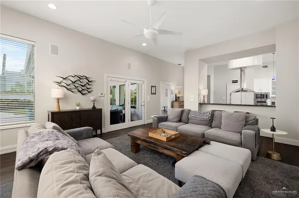 a living room with furniture ceiling fan and a window