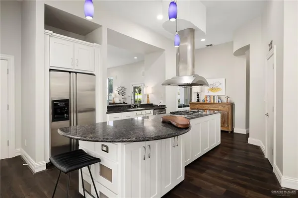 a kitchen with stainless steel appliances granite countertop a sink a refrigerator and a stove