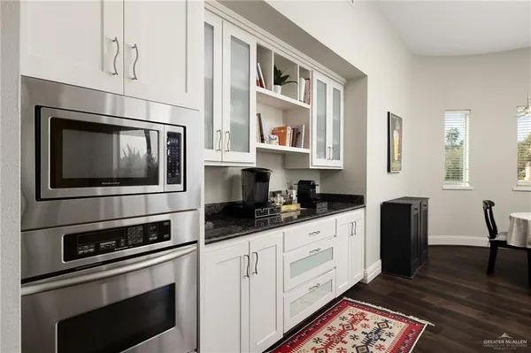 a kitchen with stainless steel appliances a stove microwave and cabinets