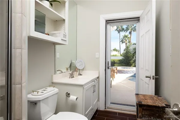 a bathroom with a sink mirror vanity and toilet