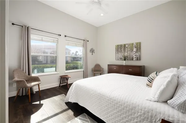 a bedroom with a bed and a large window