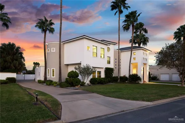 a front view of a house with garden and plants