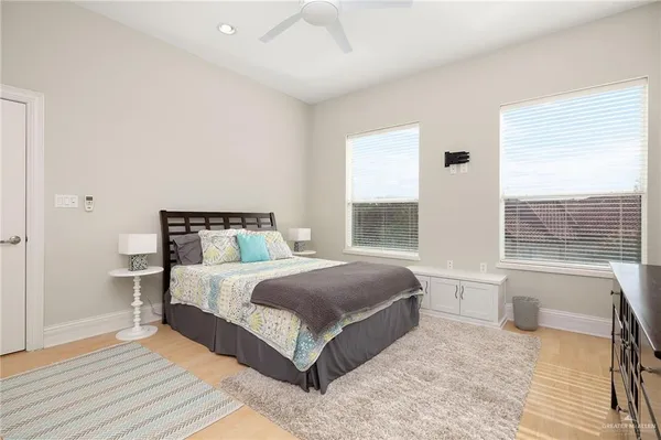 a spacious bedroom with a large bed and a large window