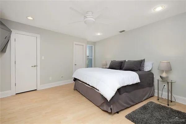 a bedroom with a bed and a night stand