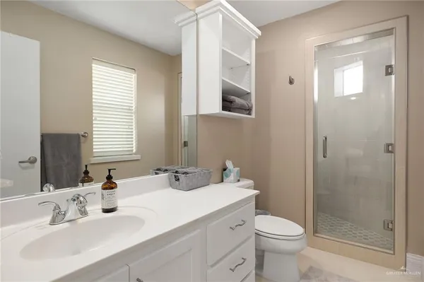 a bathroom with a sink toilet and shower
