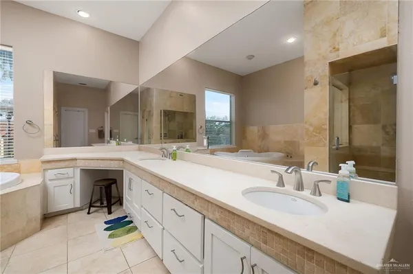 a spacious bathroom with a sink double vanity and a mirror