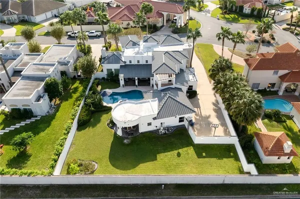 an aerial view of residential houses with yard