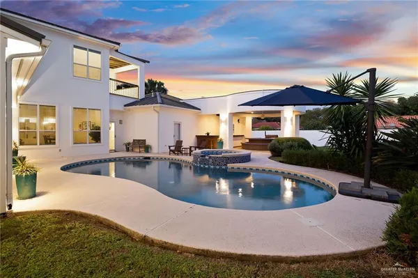 a view of a house with swimming pool and sitting area