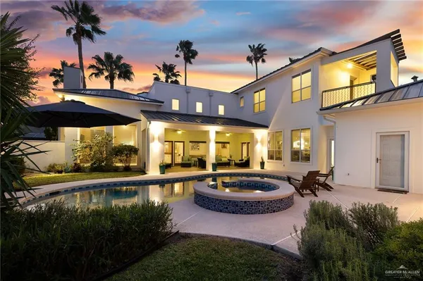 a view of a swimming pool with a patio and a garden