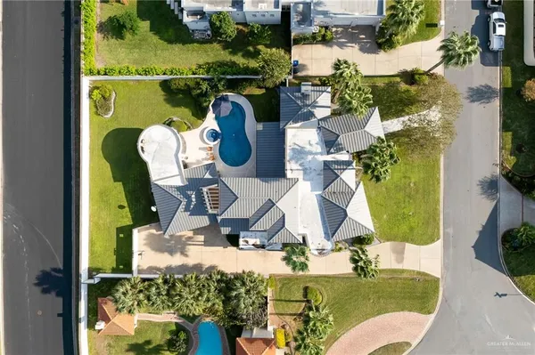 an aerial view of a house with swimming pool garden and patio