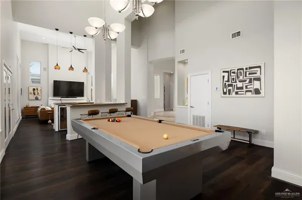 a room with table chairs and flat screen tv