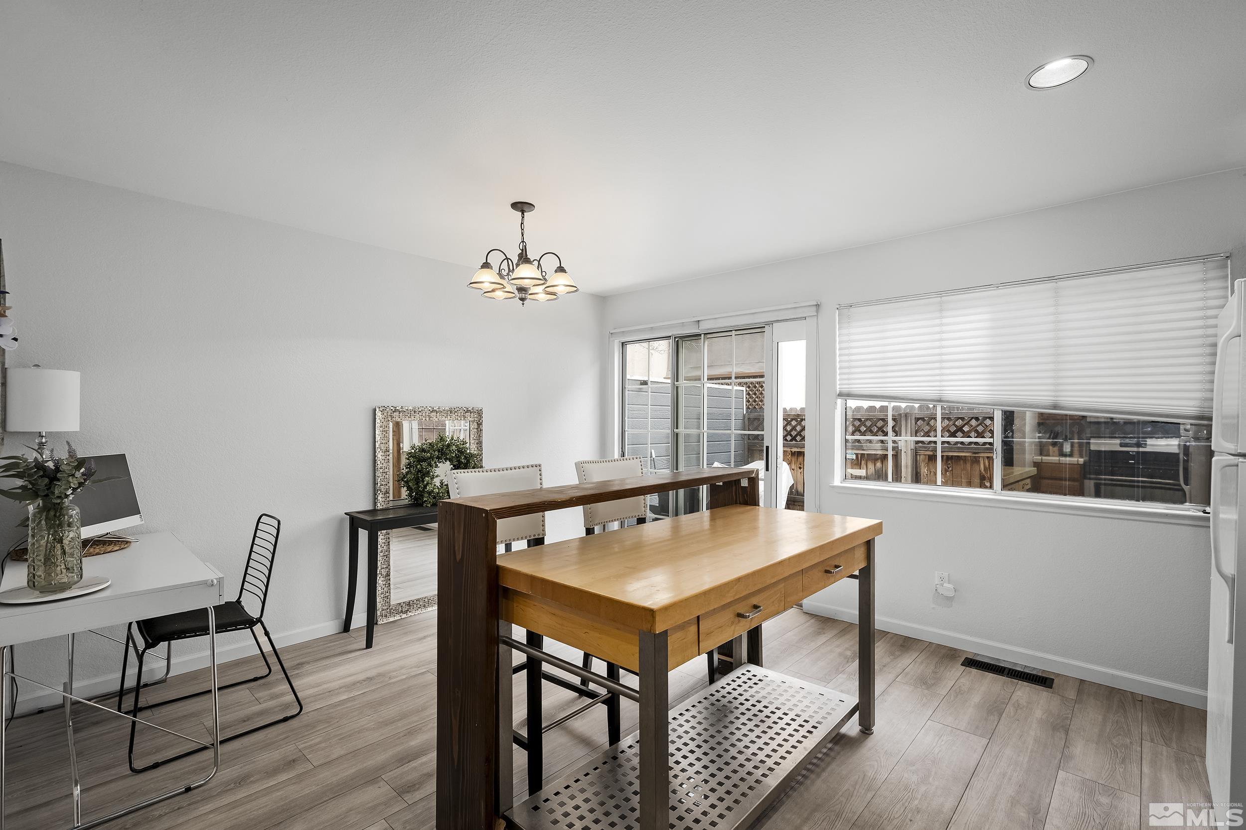 2650 Plumas Street, Unit 13 Reno, NV 89509 - Photo 13 of 23 a view of a dining room with furniture window and wooden floor