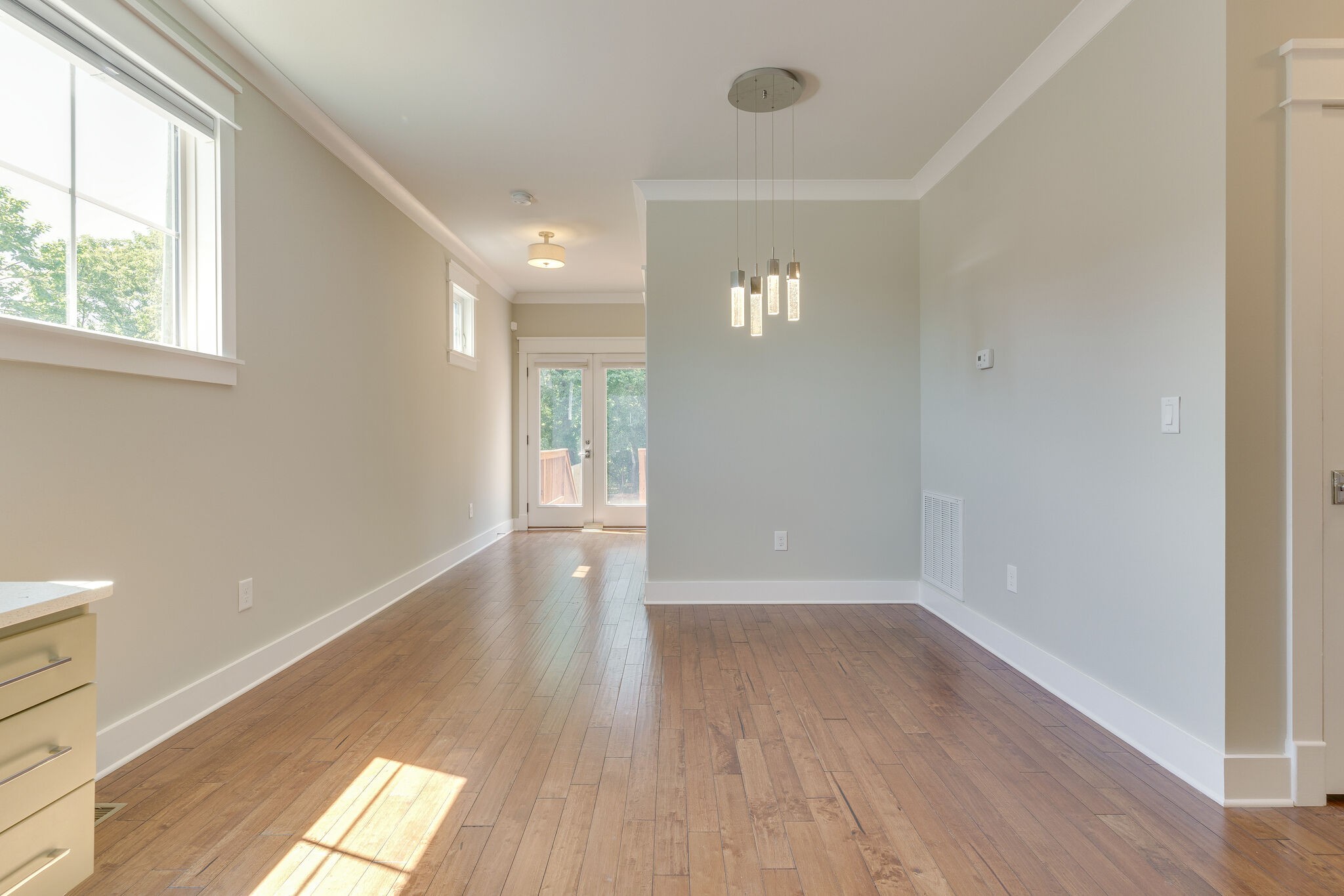1711 Ridley Boulevard Nashville, TN 37203 - Photo 13 of 49 an empty room with wooden floor and windows