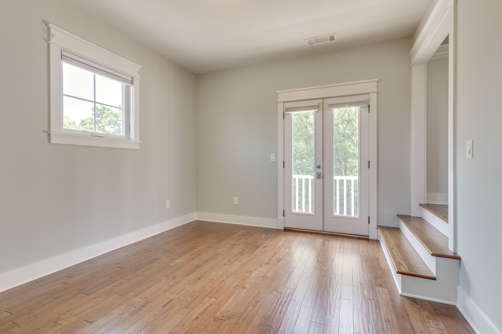 1711 Ridley Boulevard Nashville, TN 37203 - Photo 16 of 49 a view of an empty room with wooden floor and a window