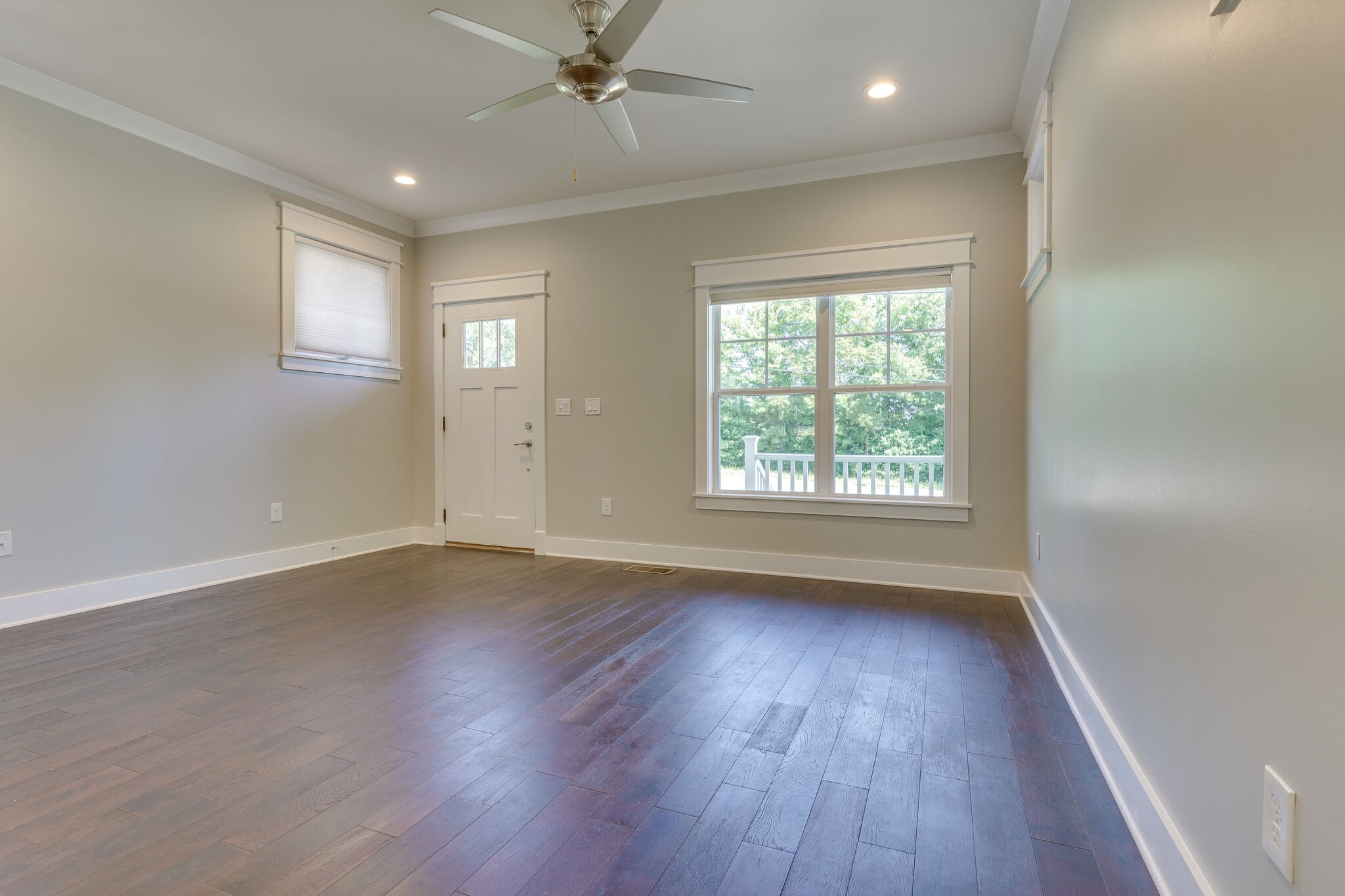 1711 Ridley Boulevard Nashville, TN 37203 - Photo 30 of 49 an empty room with wooden floor chandelier fan and windows